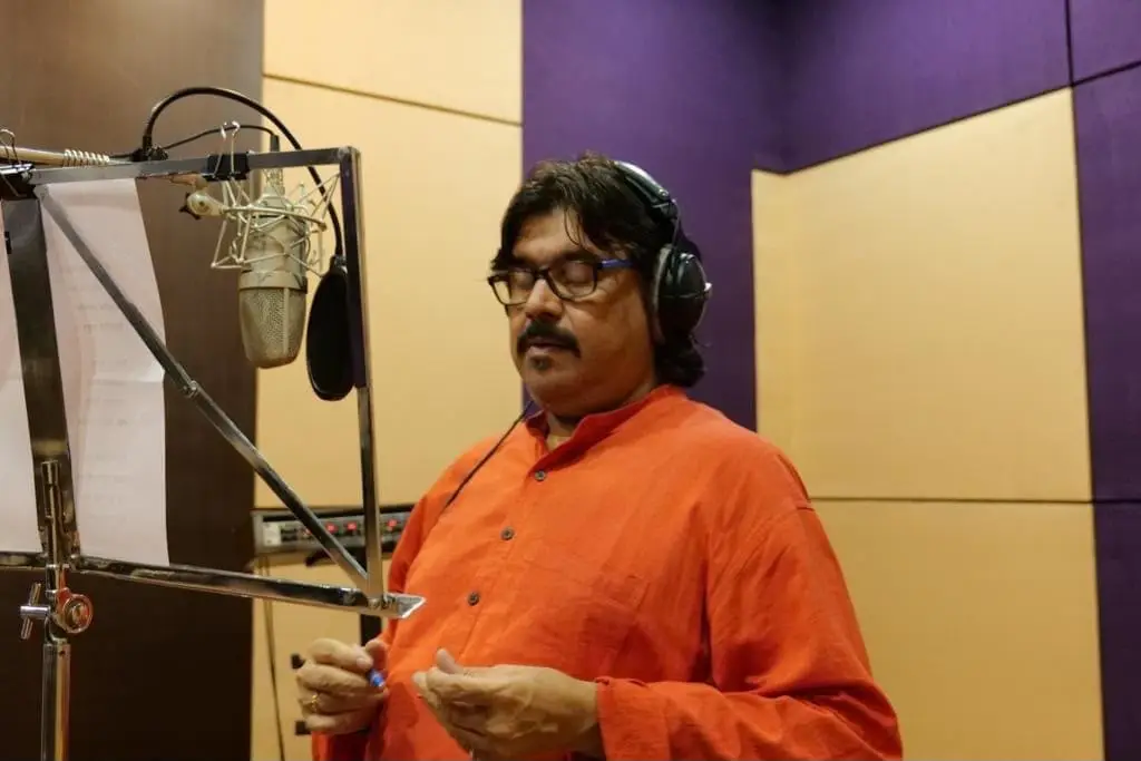 Singer recording at the microphone in the studio
